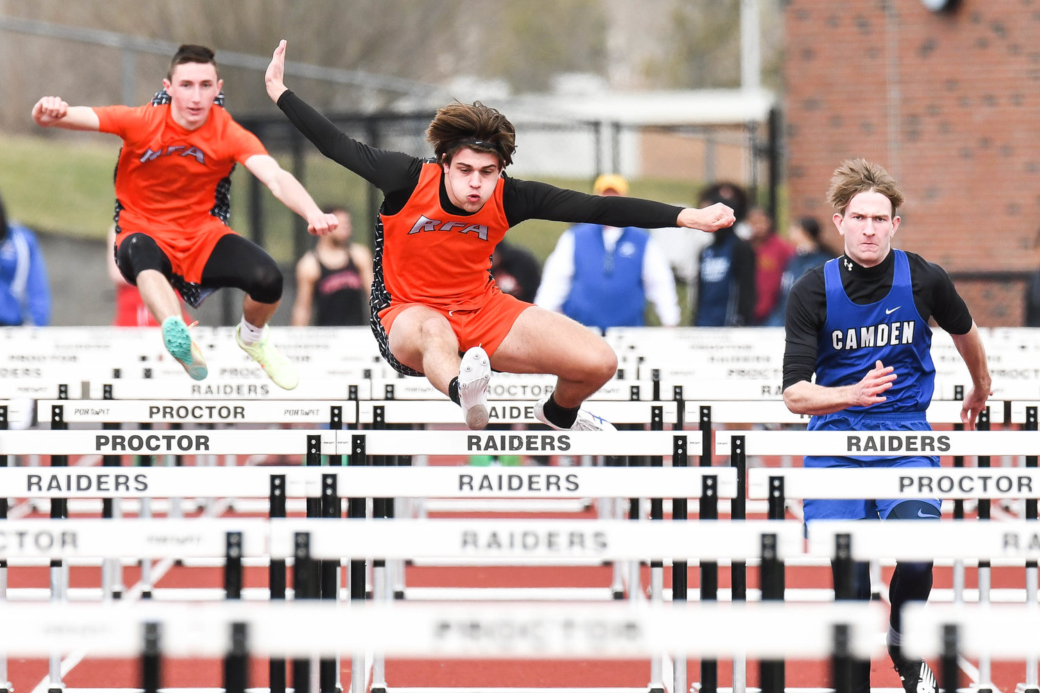 Rome Free Academy's Collin Gannon, center, competes in the 110-meter hurdle event during a track and field relay meet on Tuesday at PHS Stadium in Utica. RFA was third at the Tri-Valley League relay event behind Proctor and Camden.