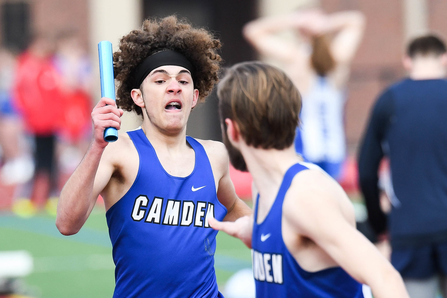From left, Camden's Elijah Jackson hands the baton off to a teammate in the distance medley relay during the track and field meet on Tuesday at PHS Stadium in Utica.
