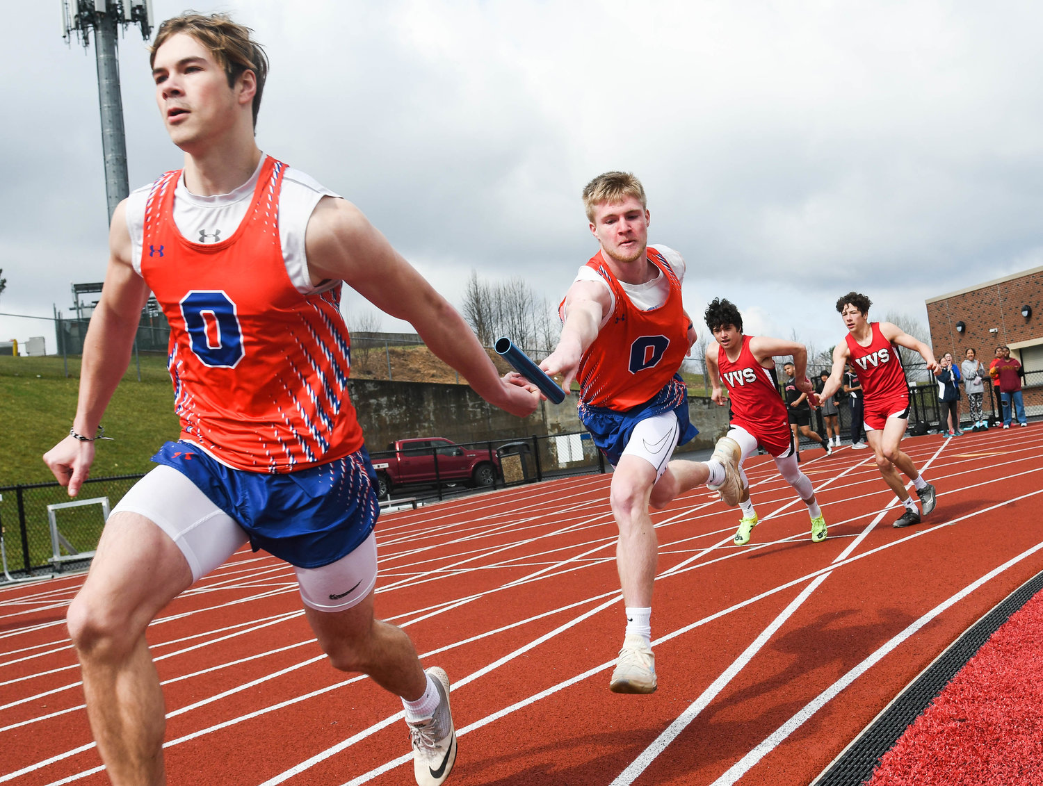 From left, Oneida runner Ryan Wuest receives the baton from teammate Avery Baker during a 4 by 100 meter relay on Tuesday.