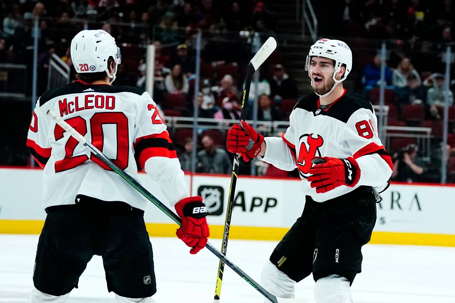 MILESTONE — Kevin Bahl, right, celebrates his first NHL goal with center Michael McLeod (20) during the second period of the team’s game against the Arizona Coyotes on Tuesday night.