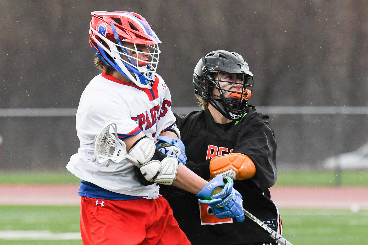SCORING TOUCH — New Hartford's Gavin Williams, left, fires a shot against Rome Free Academy defender Kaden Elliott during a lacrosse game on Thursday at New Hartford. The Spartans won 17-4. Williams had two goals and an assist.
