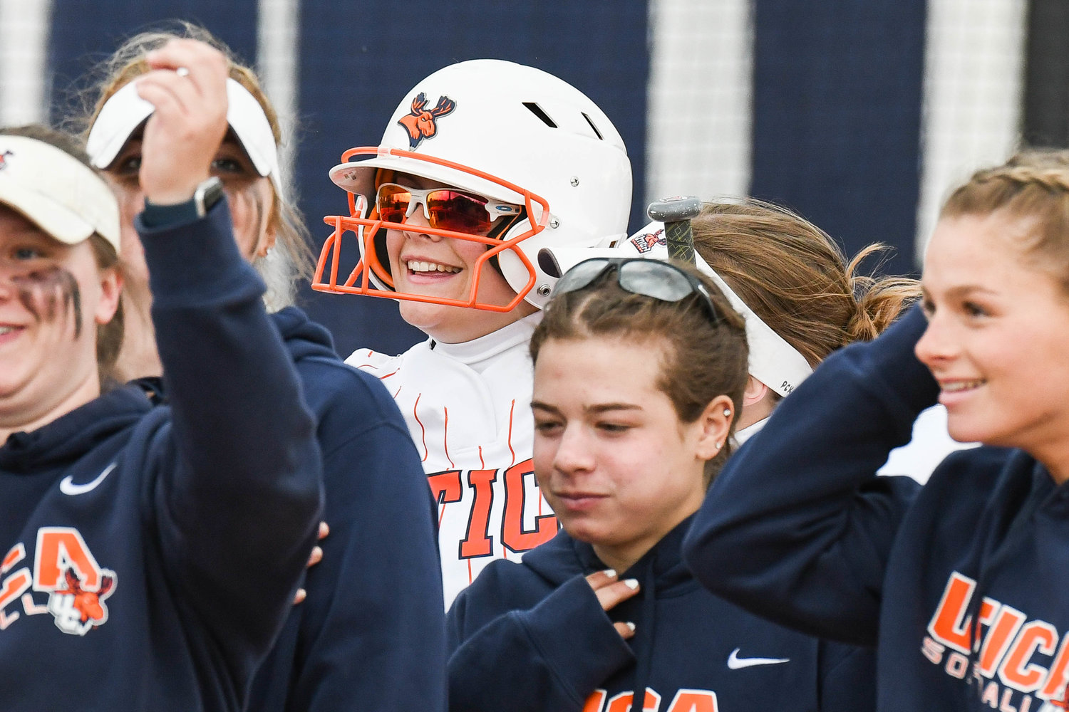 ALL SMILES — Utica University player Lauren Paul, center, smiles after hitting a home run during game two of a doubleheader against Russell Sage on Friday at Greenman Softball Field in Utica. The Pioneers split the twin bill with Russell Sage winning game two, 12-7. The Pioneers, who are 11-15 overall, lost game one, 2-1.