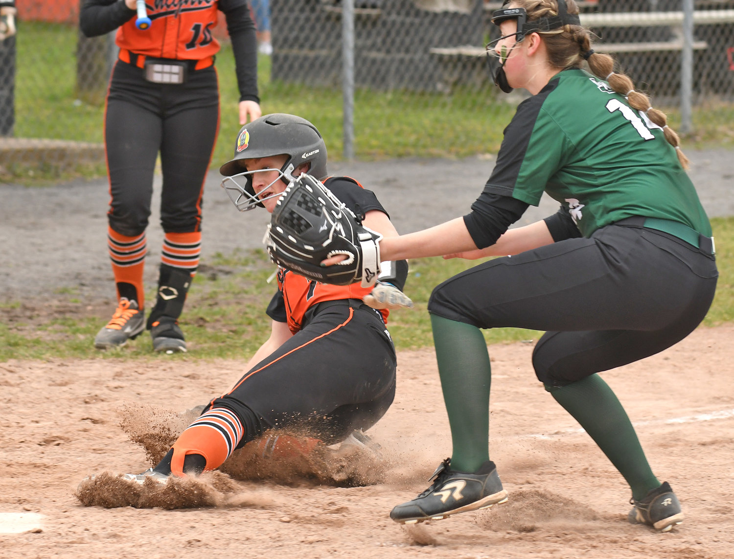 SAFE AT HOME — Rome Free Academy baserunner Lauren Dorfman slides home safely in front of Fayetteville-Manlius Natalie Mayne in the first inning of Monday’s game at Kost Field in Rome. RFA lost 4-3. Dorfman had two hits and two runs scored.