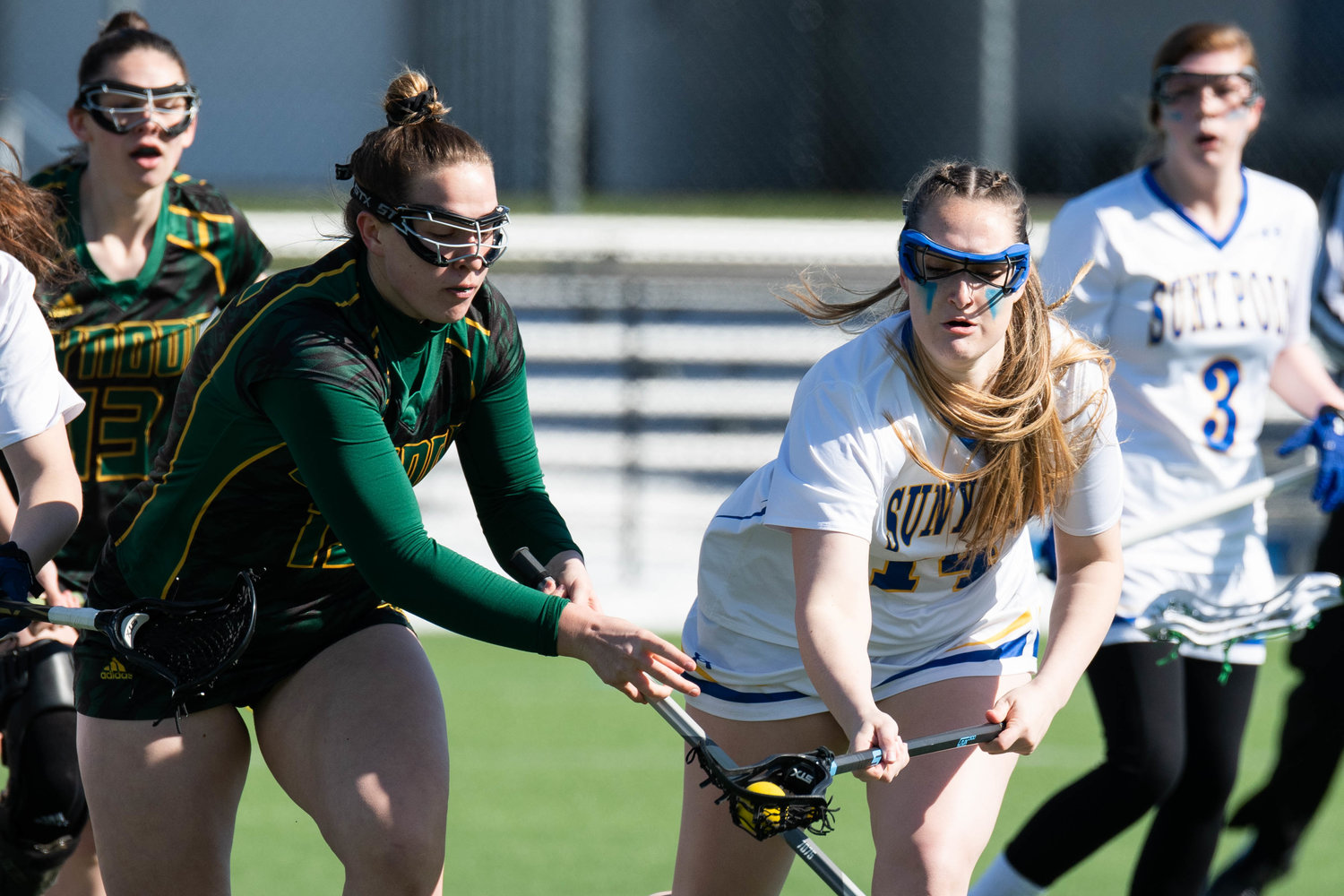 FIGHTING FOR CONTROL — SUNY Polytechnic Institute player Emma Draper, right, fights for control of the ball during the game against Northern-Vermont Lyndon on Wednesday. The Wildcats won 18-4.