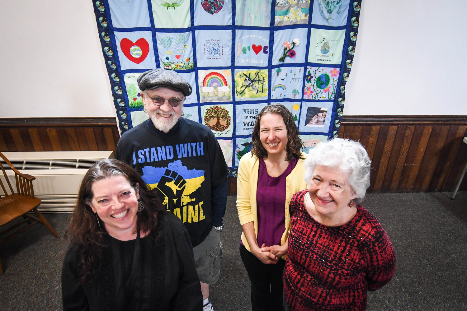 MAKING A DIFFERENCE — Supporters of “Melissa” and her CNY Green Bucket Project, the only food scrap collection service in the area, stand before an Earth Day quilt they helped create that’s now on display at Kirkland Town Library on College Street, Clinton. From left, back: Kevin Conley, and owner Melissa.  From left, front: Sharen Barboza and Sally Carman.