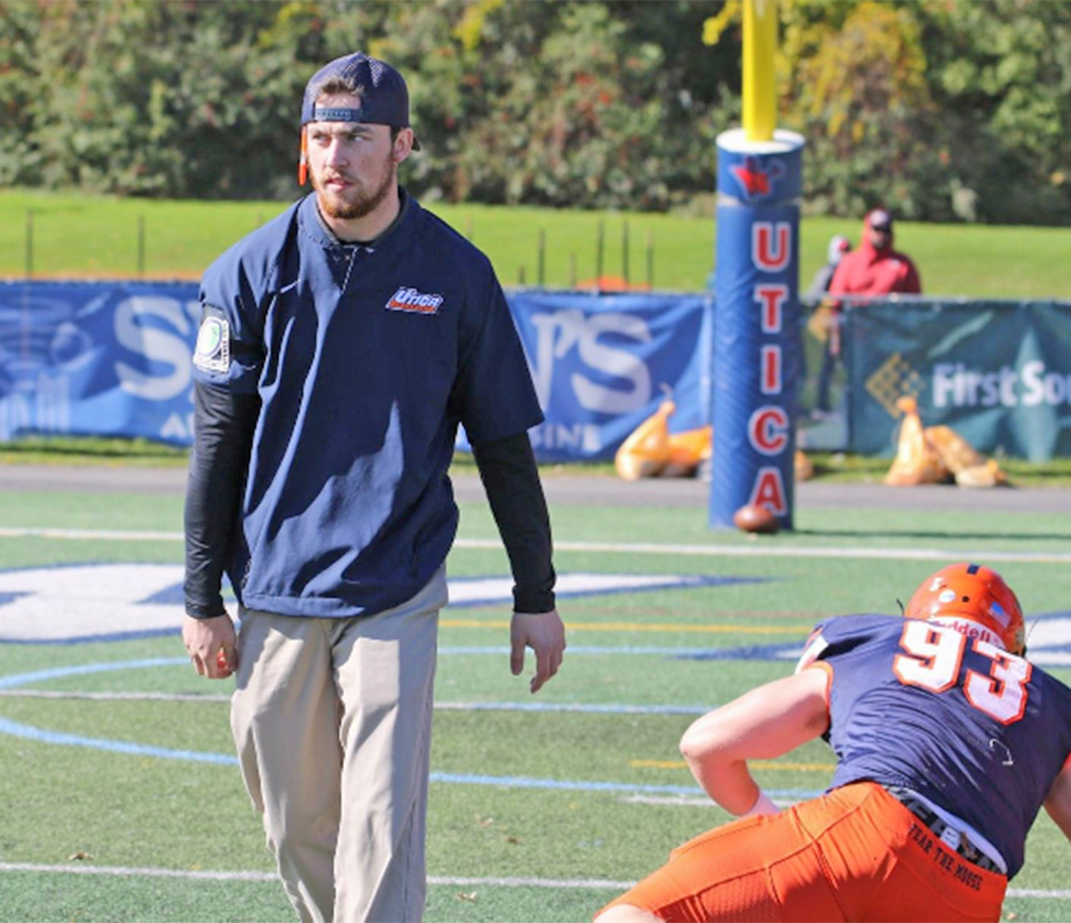 TAKING THE REINS AT ONEIDA — Matt McCoy walks the field at then-Utica College as a defensive coach before a game. McCoy, a Vernon-Verona-Sherrill graduate and former UC defensive back, has been chosen as the new varsity head football coach at Oneida.