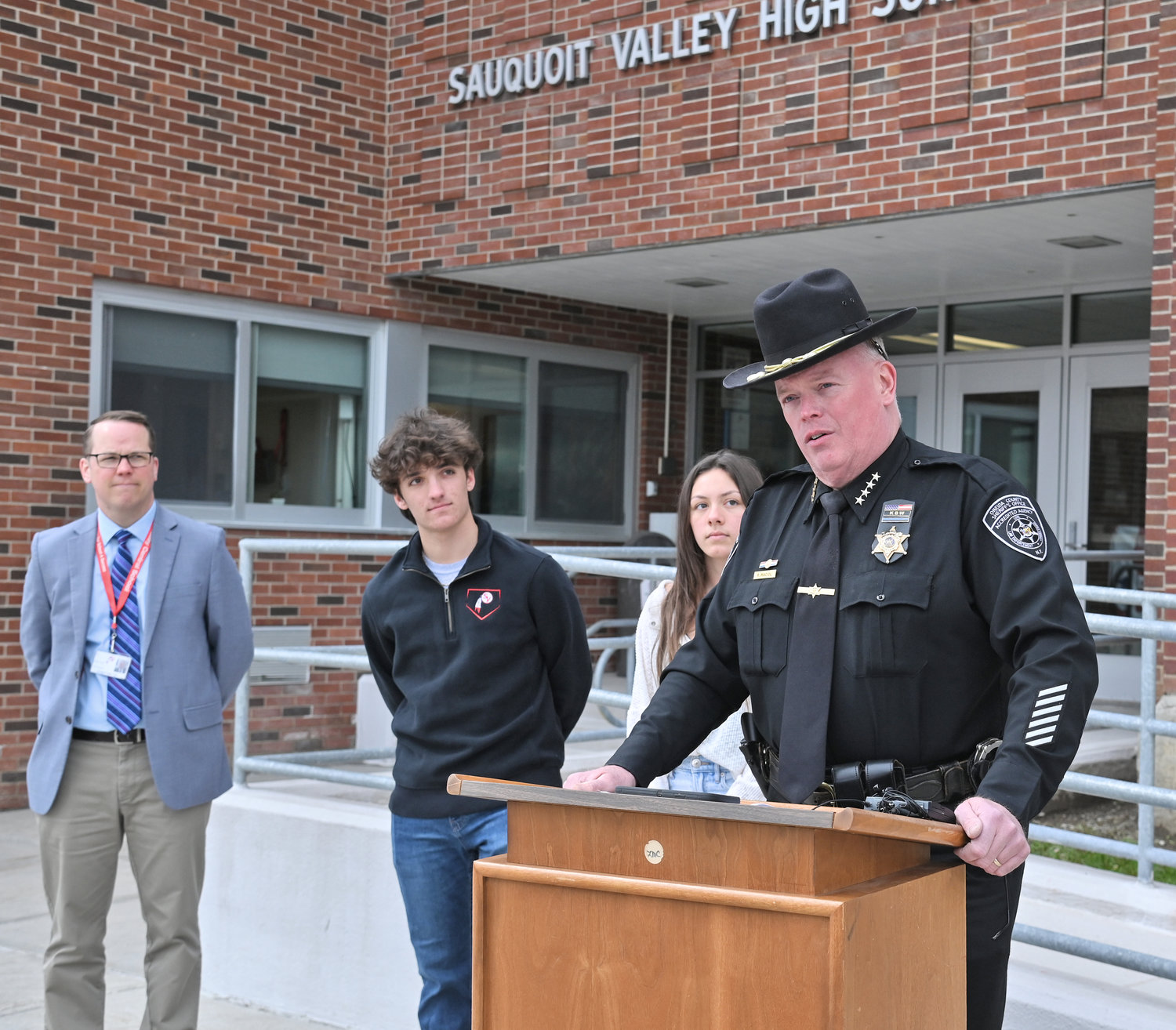 NO EMPTY CHAIR — Oneida County Sheriff Robert M. Maciol joined Sauquoit Valley High School students Friday morning to announce the upcoming No Empty Chair Campaign next week. From left: Principal Brian Read, senior class president Benjamin LoGalbo, student council president Alena Weibel, and Maciol.