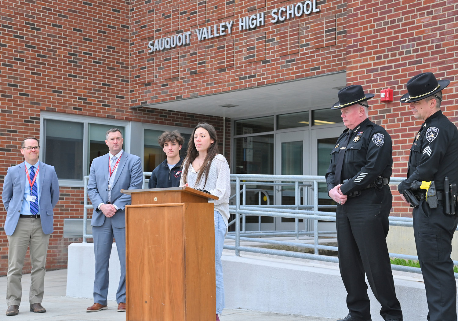 POWERFUL VOICES — Student council president Alena Weibel talks about the importance of staying safe during prom season at Sauquoit Valley High School on Friday, kicking off the No Empty Chair campaign for next week. Weibel was joined by, from left, Principal Brian Read, Superintendent Ronald Wheelock, senior class president Benjamin LoGalbo, Oneida County Sheriff Robert M. Maciol, and Sgt. Carey Phair.