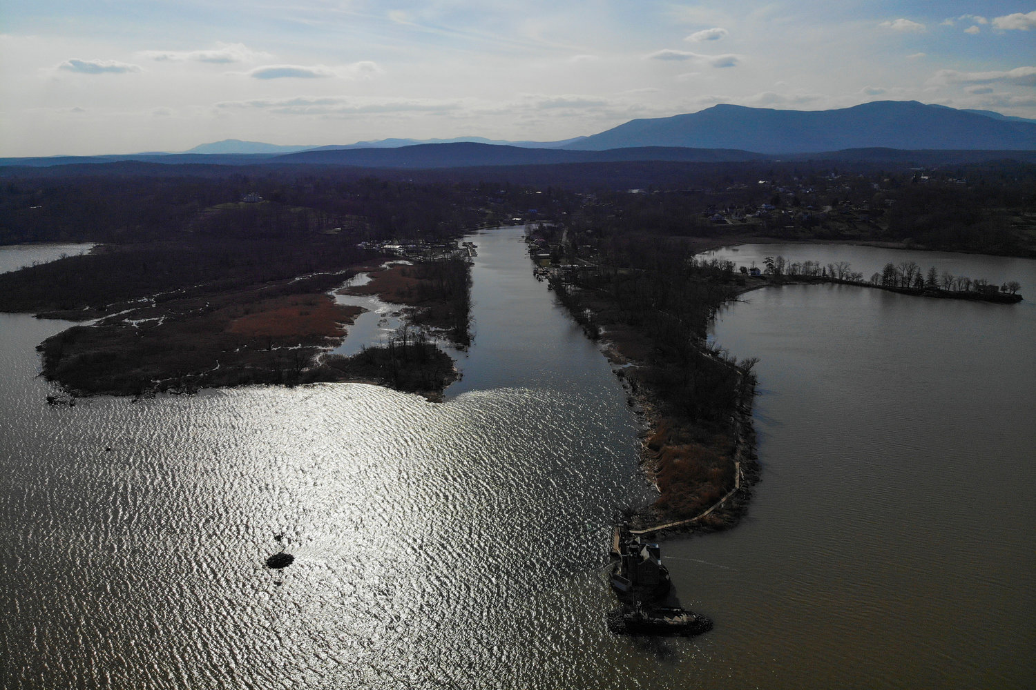 The Esopus Creek, center, empties out into the Hudson River in Saugerties, N.Y., Tuesday, April 5, 2022. As western regions contend with drier conditions, New York City is under fire for sometimes releasing hundreds of millions of gallons of water a day from the Ashokan reservoir in the Catskill Mountains. The occasional releases, often around storms, have been used to manage water the reservoir's  levels and to keep the water clear. But residents downstream say the periodic surges cause ecological harm along the lower Esopus Creek. (AP Photo/Seth Wenig)