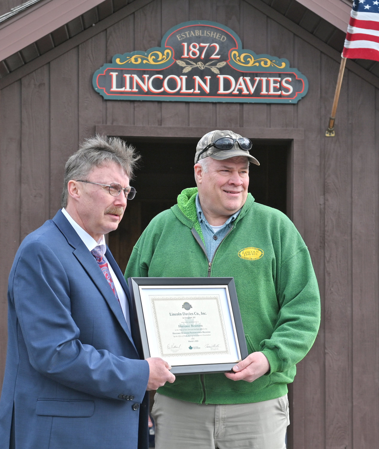 HERE’S TO HISTORY — Assemblyman Brian Miller, R-101, New Hartford, left, presents Ed Jones, owner of Lincoln Davies Company, with its historic business recognition certificate during a ceremony on Friday. The company, located at 8689 Summit Road in Sauquoit, was named to the New York State Historic Business Preservation Registry.