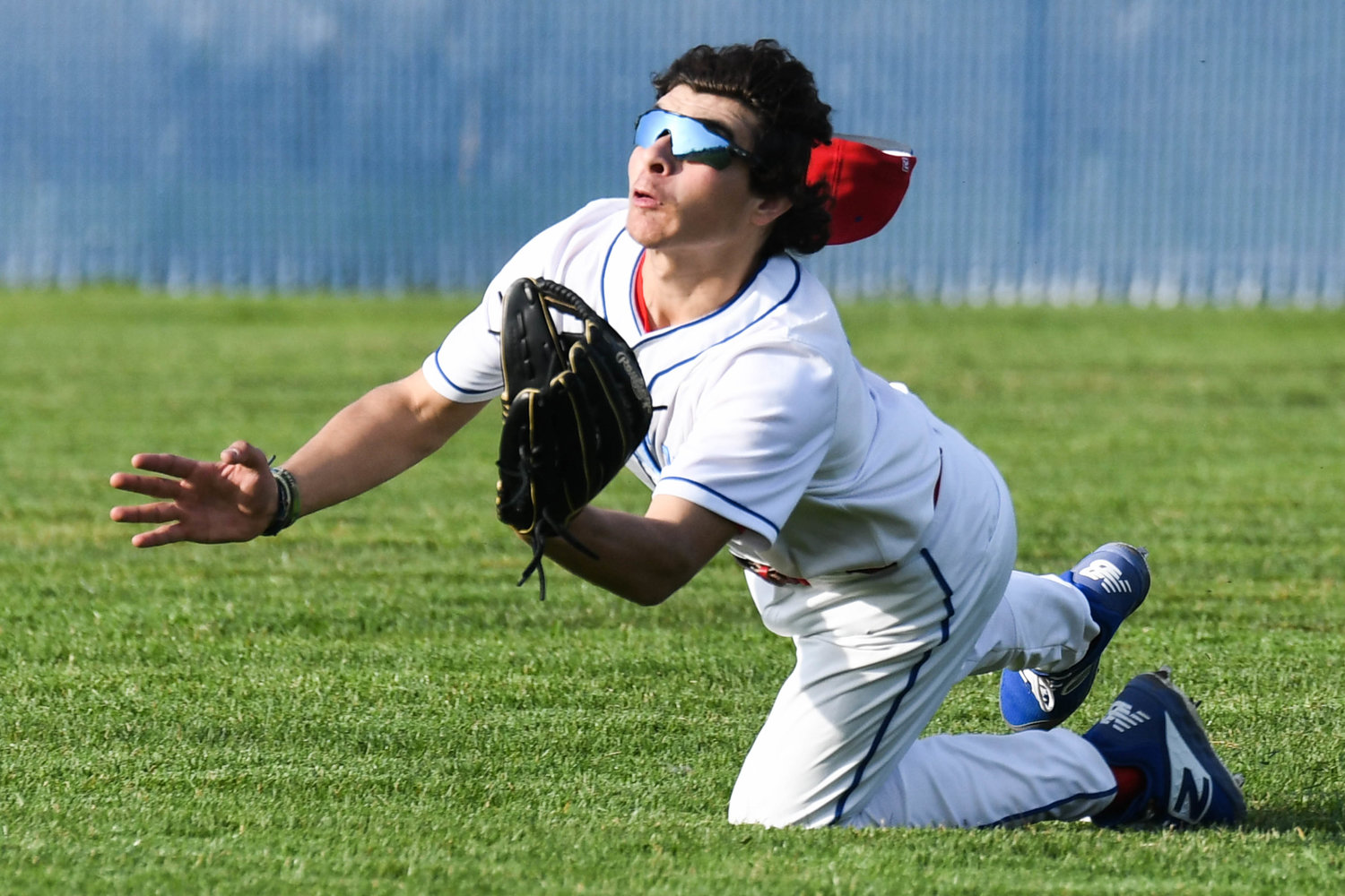 MAX EFFORT — New Hartford’s Derek DeFazio makes a diving catch in right field during the game against Rome Free Academy on Monday at home. The Spartans won 3-2.