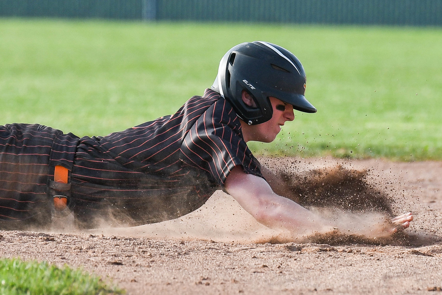 GET BACK — Rome Free Academy baserunner Jacob Premo slides safely back into second base during the game against New Hartford on Monday. Premo scored one of RFA's two runs but it wasn't quite enough, as the Spartans won 3-2. Premo went the distance on the mound for the Black Knights.