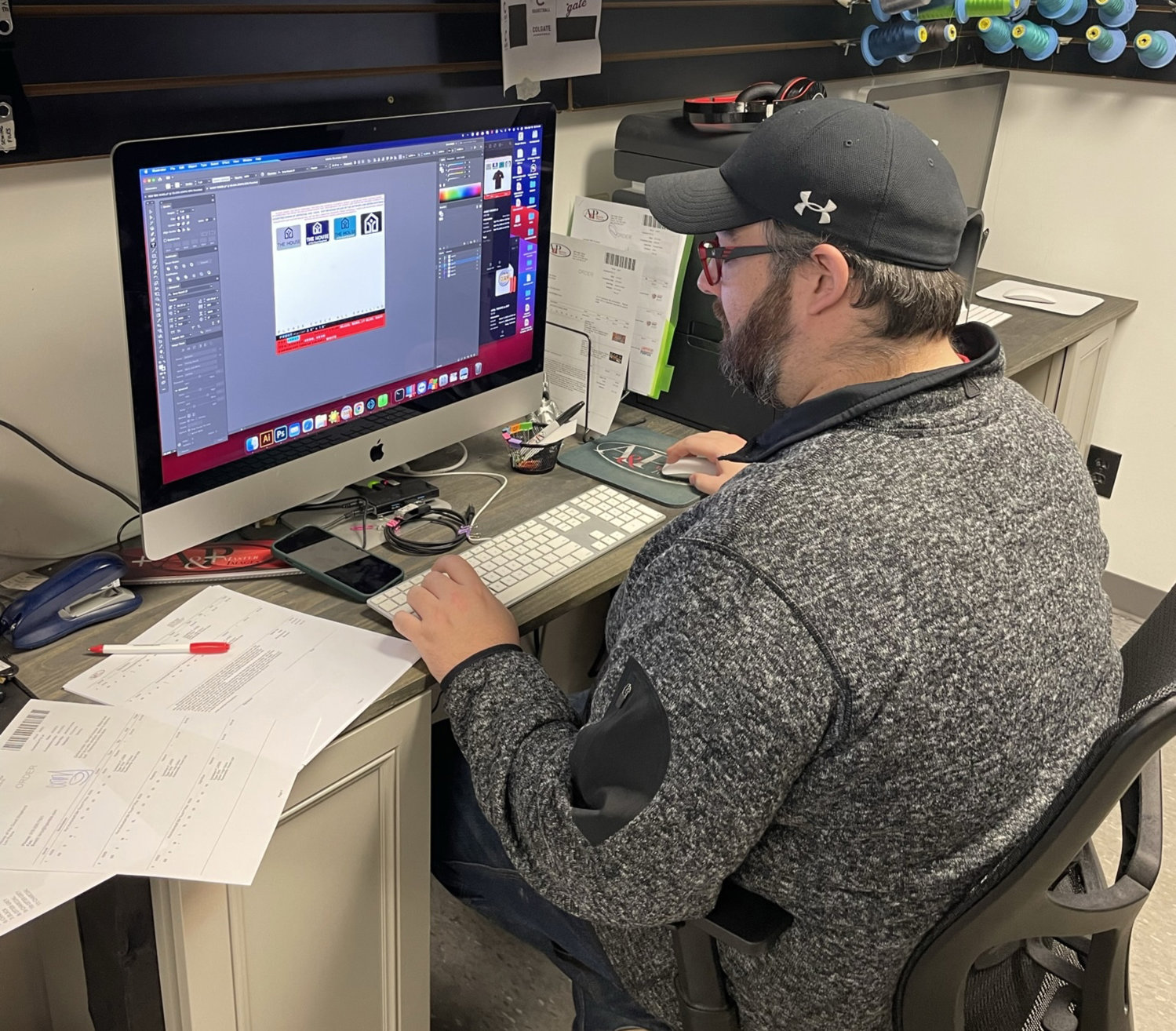 DESIGN WORK — PJ Loomis, design manager at A&amp;P Master Images, works on a graphics design for a client.