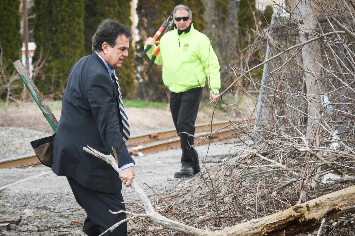 HANDS-ON MAYOR — Utica Mayor Robert Palmieri clears a fallen tree branch on Schuyler Street on Wednesday, as part of his weekly Quality of Life Sweep series. The sweeps are conducted in different neighborhoods throughout the year to touch base with the community and clean up the streets and sidewalks. It also gives local business owners a chance to express concerns or make suggestions.