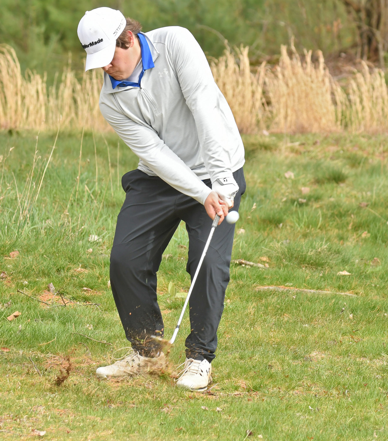 GOING FOR THE GREEN — Whitesboro’s Chris Stilwell chips to the 11th green in the Warriors’ match against Rome Free Academy at Rome Country Club Wednesday. Stillwell shot a 42, one stroke behind Mike Stilwell’s 41. The Warriors won 229 to 280.