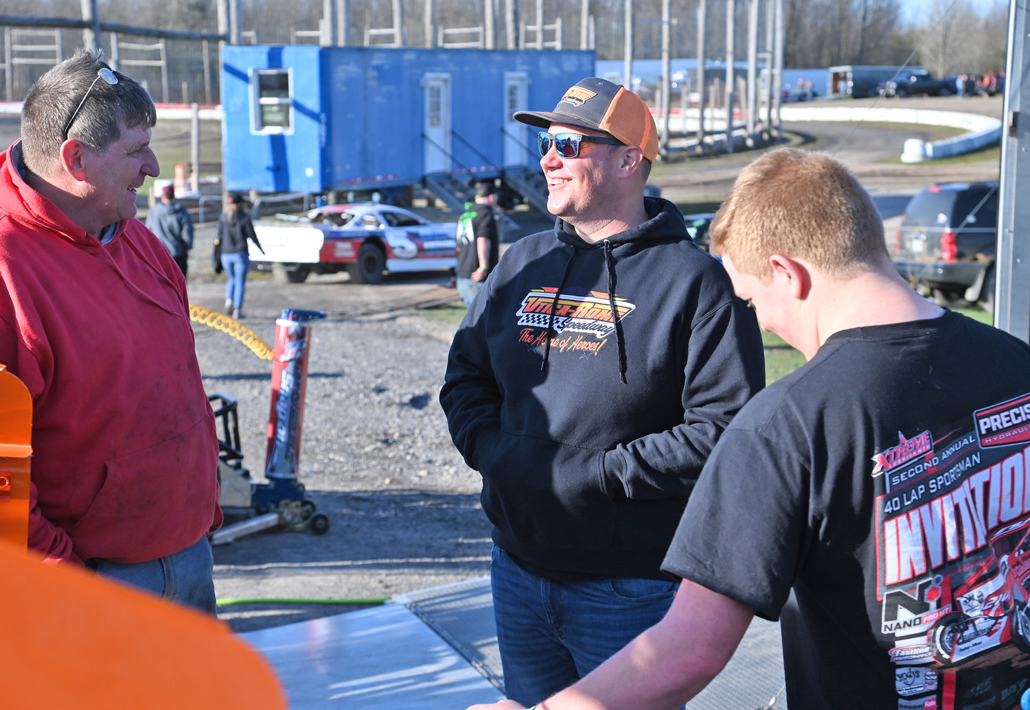 OPEN PRACTICE — Utica-Rome Speedway promoter Brett Deyo, center, talks with Tyler Talbot, left, and Payton Talbot in the pits last Friday night. Deyo says the best way to keep racers happy is with a good racing surface and a great payout.