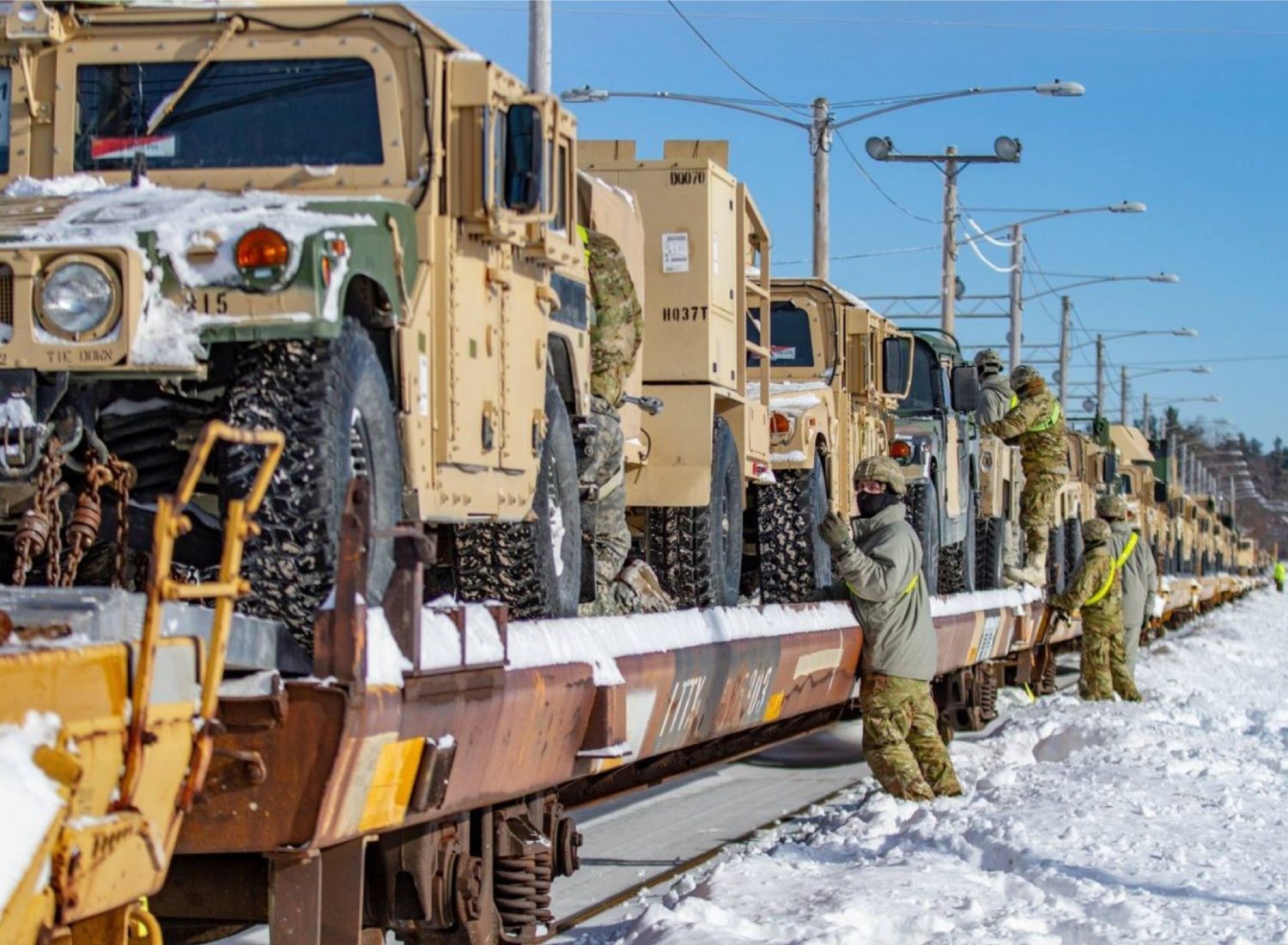 BIG IMPACT — Soldiers with the 10th Mountain Division at Fort Drum in Watertown secure vehicles on a flatbed train car in this file photo included in Fort Drum’s 2021 economic impact report.  According to the report, Fort Drum had an economic impact of more than $1.5 billion on the North Country.