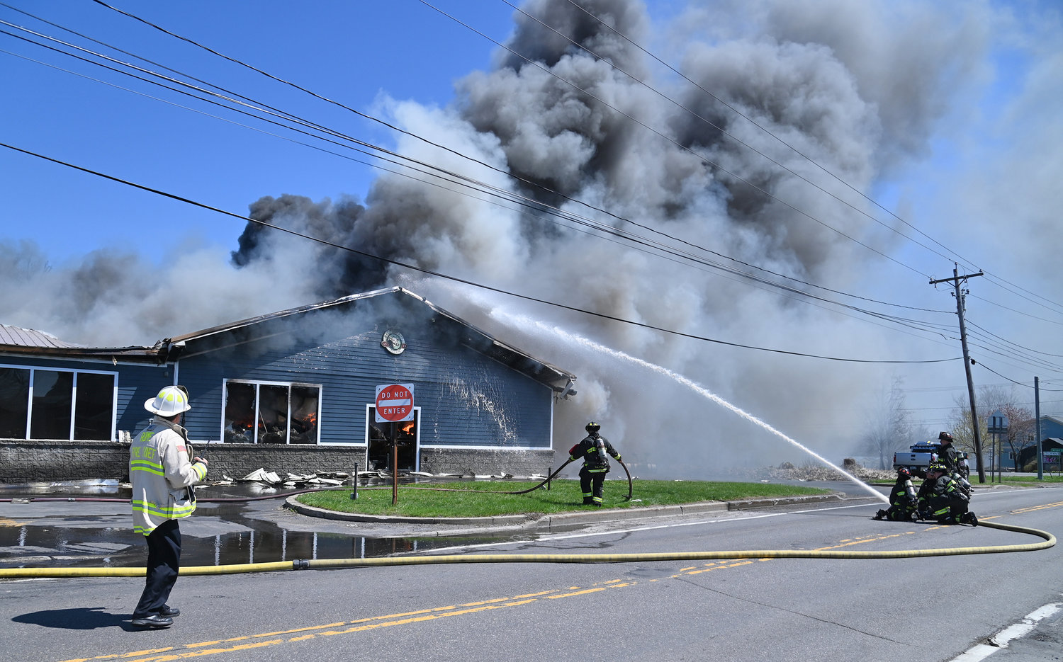 FOCUSED HOSE — One of several hose lines blasts water into the burning Mazzaferro's Meats & Deli on Ridge Mills Road in Rome Friday afternoon.