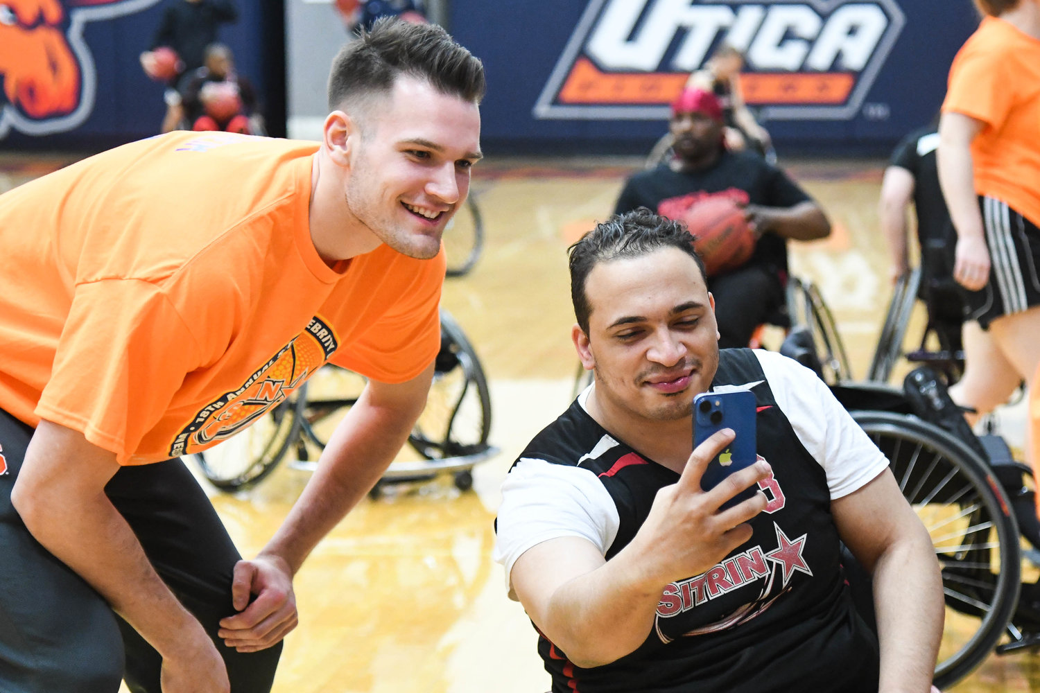 PICTURE TIME — Devon Henry takes a selfie with Syracuse Orange player Jimmy Boeheim before the start of the 18th annual Sitrin Celebrity Wheelchair Basketball Game on Thursday night at Utica University.