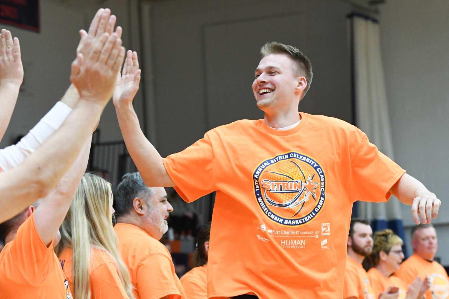 HIGH-FIVE — Syracuse Orange player Buddy Boeheim slaps hands with teammates during the start of 18th Annual Sitrin Celebrity Wheelchair Basketball Game on Thursday night at Utica University.
