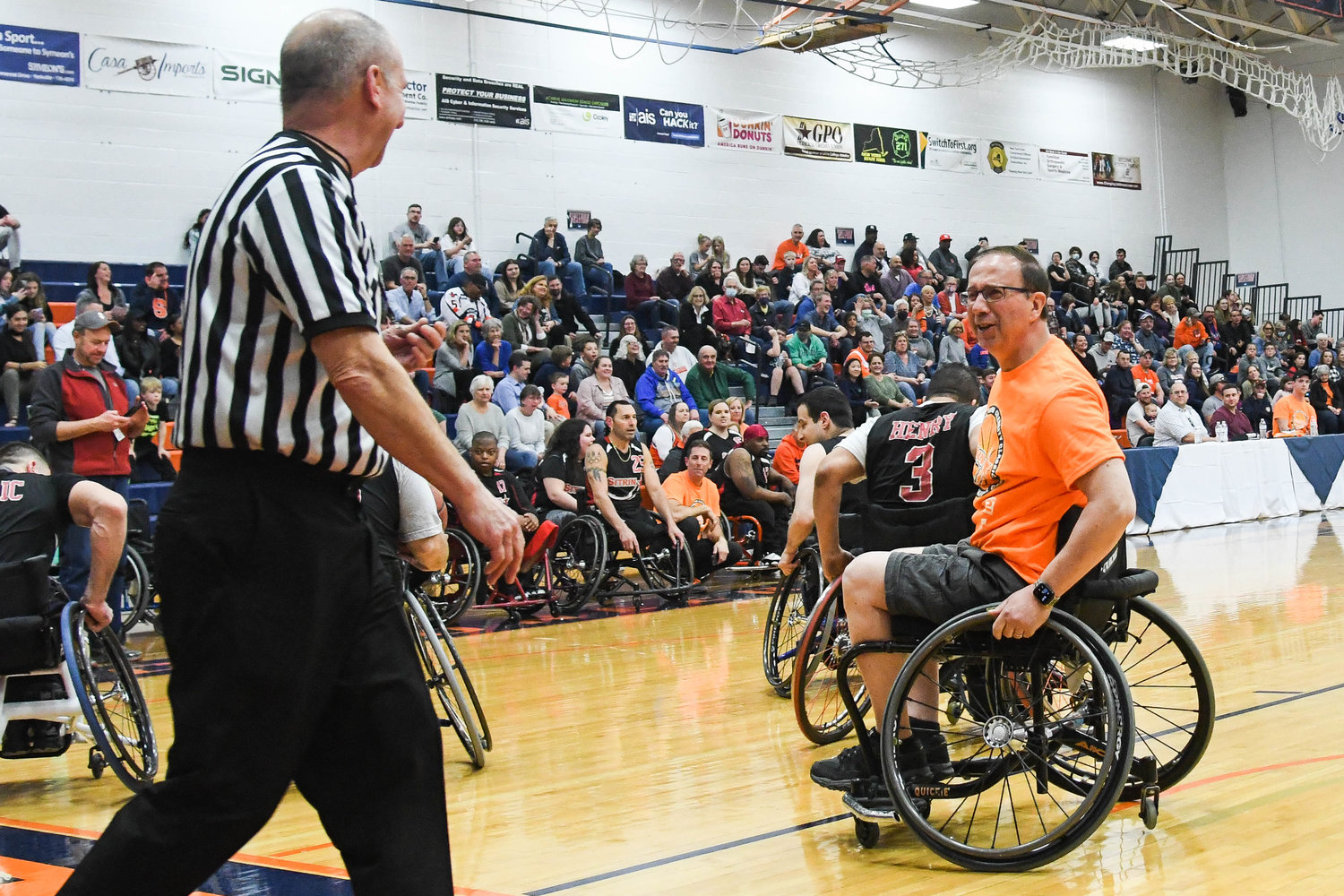 New York State Senator Joseph Griffo playfully argues a call with the referee during the 18th annual Sitrin Celebrity Wheelchair Basketball Game on Thursday night at Utica University.