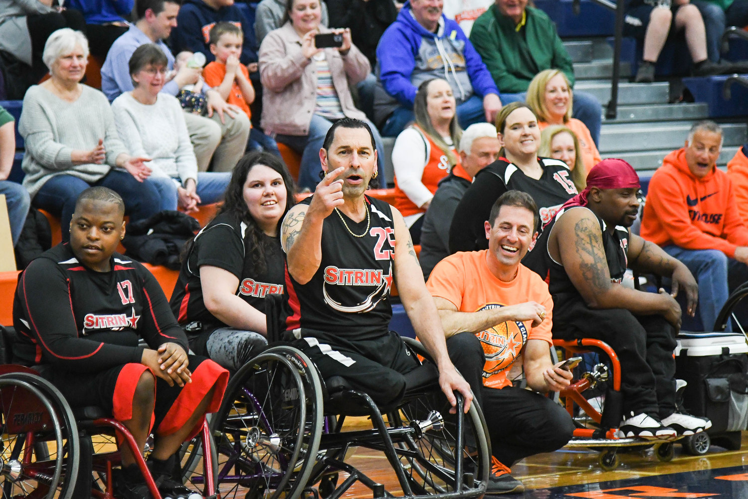 Sitrin players cheer during 18th annual Sitrin Celebrity Wheelchair Basketball Game on Thursday night at Utica University.