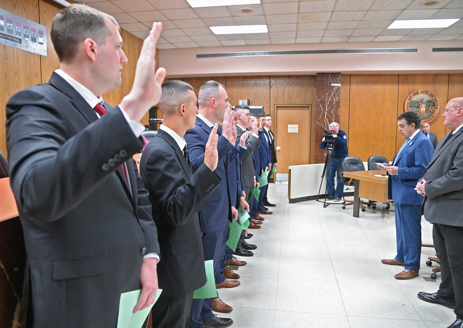 SWEARING IN — Ten new police officer recruits take their oath of office at Utica City Hall on Friday morning.
