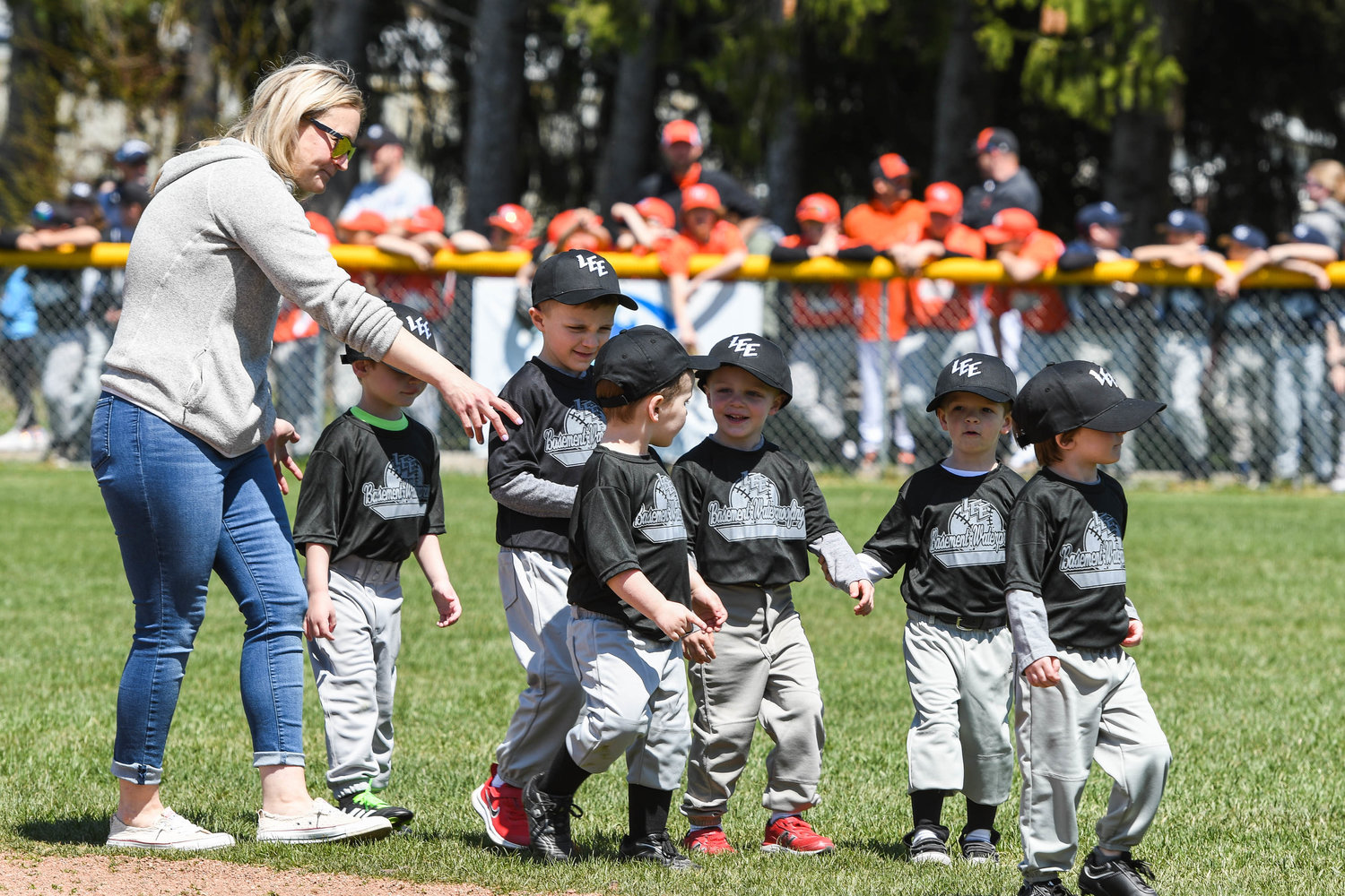 Young players from the Basement Waterproofing team are announced to the field as the Town of Lee Little League program hosts their opening day ceremony on Saturday at Lee Town Park.