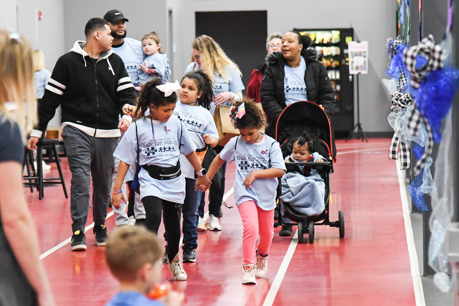 Families participate in the annual Walk for Autism on Saturday at The Fitness Mill in Utica. Guests walked laps around the indoor track and those who could not attend were able to participate virtually. The goal of the event is to raise funds for the programs the Kelberman Center provides and to raise autism awareness.