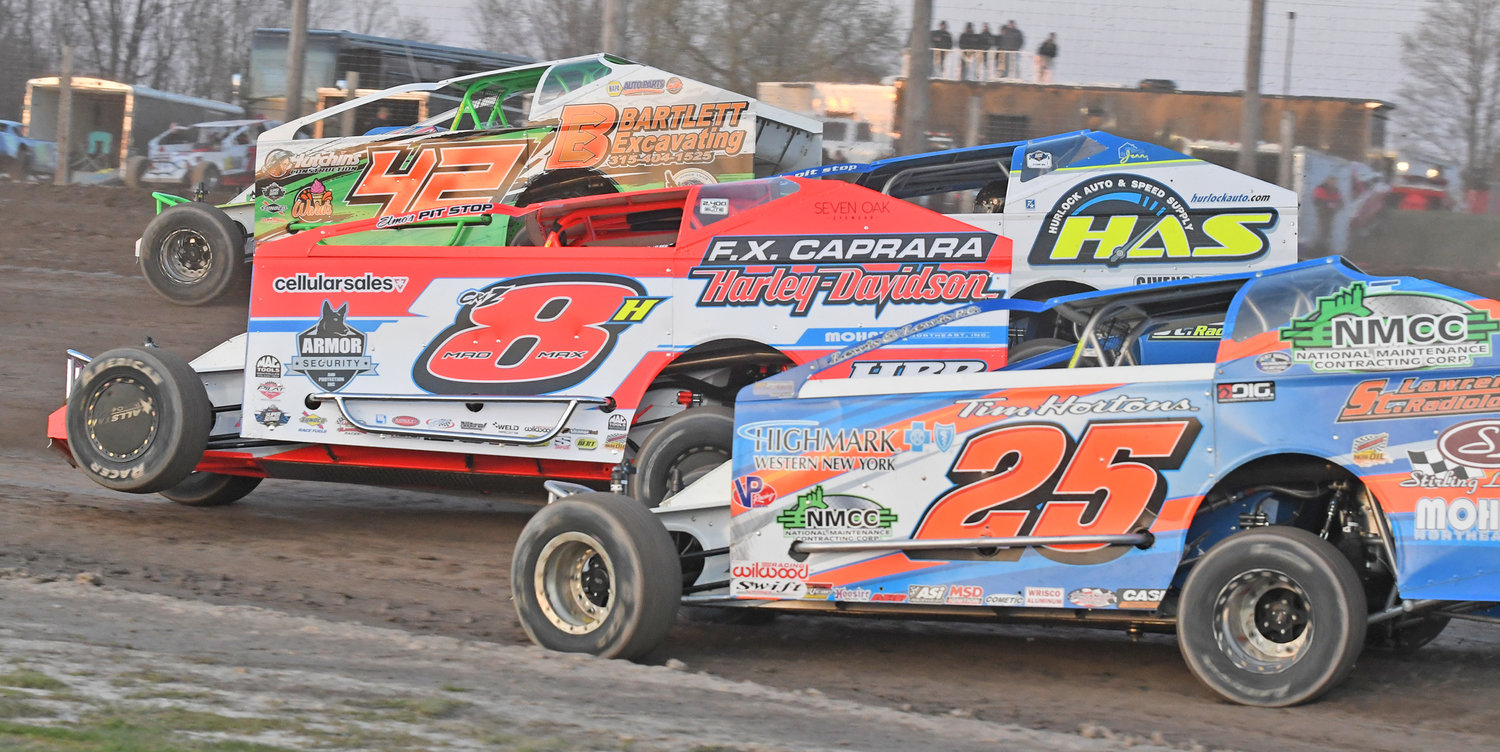 Tucker O’Connor, No. 42; Matt Sheppard, No. 9s; Max McLaughlin, No. 8H and Erick Rudolph, No. 25; race through the second turn at Utica-Rome Speedway in Vernon Friday night during heat race action on opening night of the 2022 season. Sheppard went on to win the feature race and McLaughlin finished third, Rudolph 13th and O’Connor 22nd.
