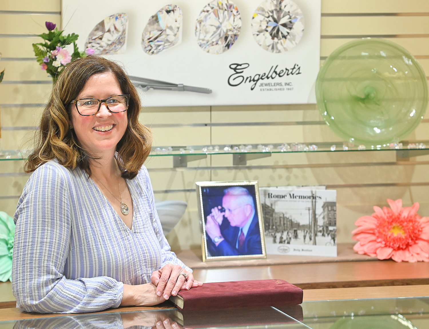 Sarah Engelbert Rushton, current owner of Engelbert’s Jewelers on West Dominick Street, stands behind the counter of her store.  Engelbert’s is celebrating 115 years in business.