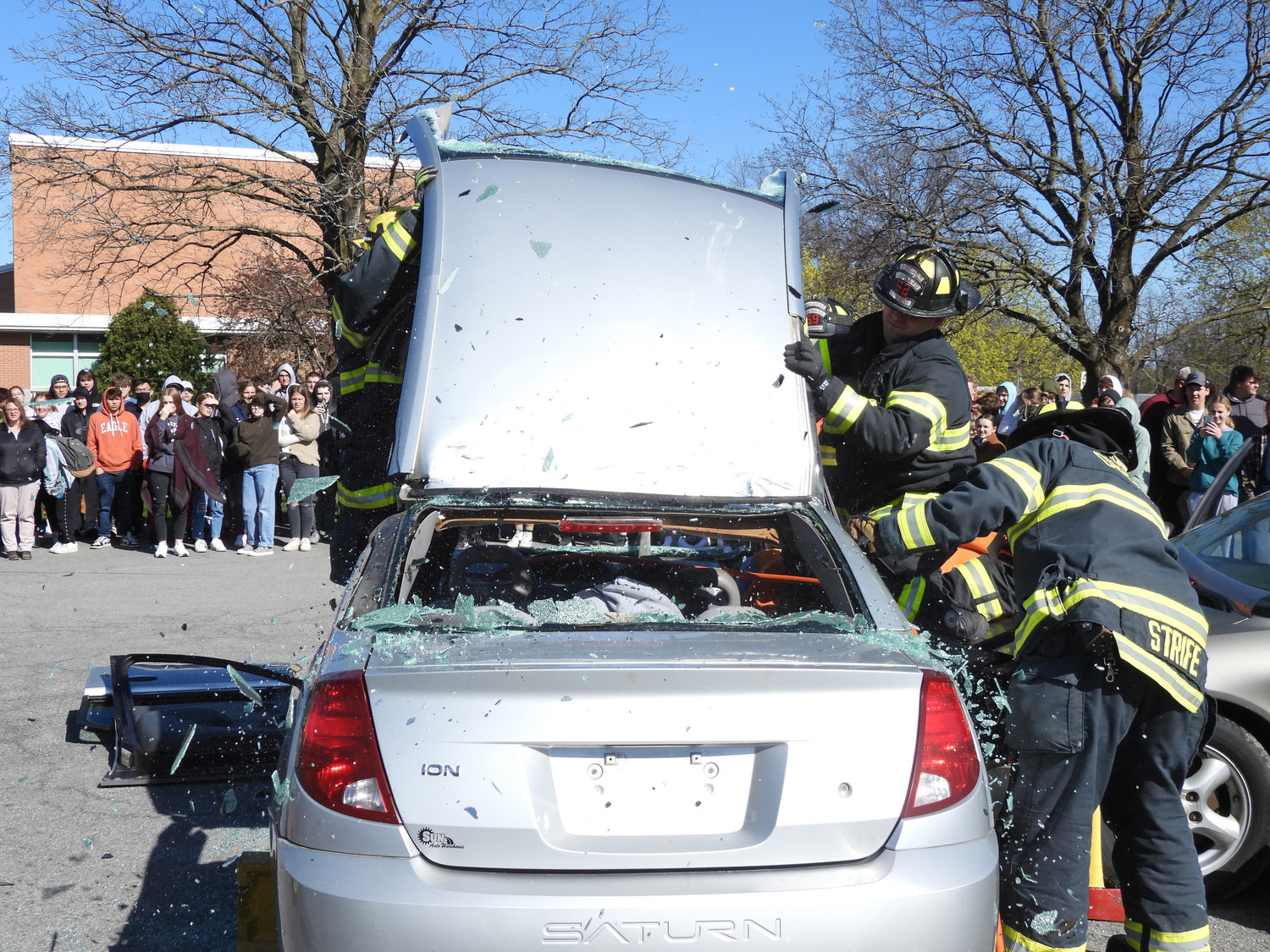 The Oneida Fire Department tears open a car after cutting it apart with hydraulic tools to safely remove DWI victims as part of the Oneida High School's Mock DWI