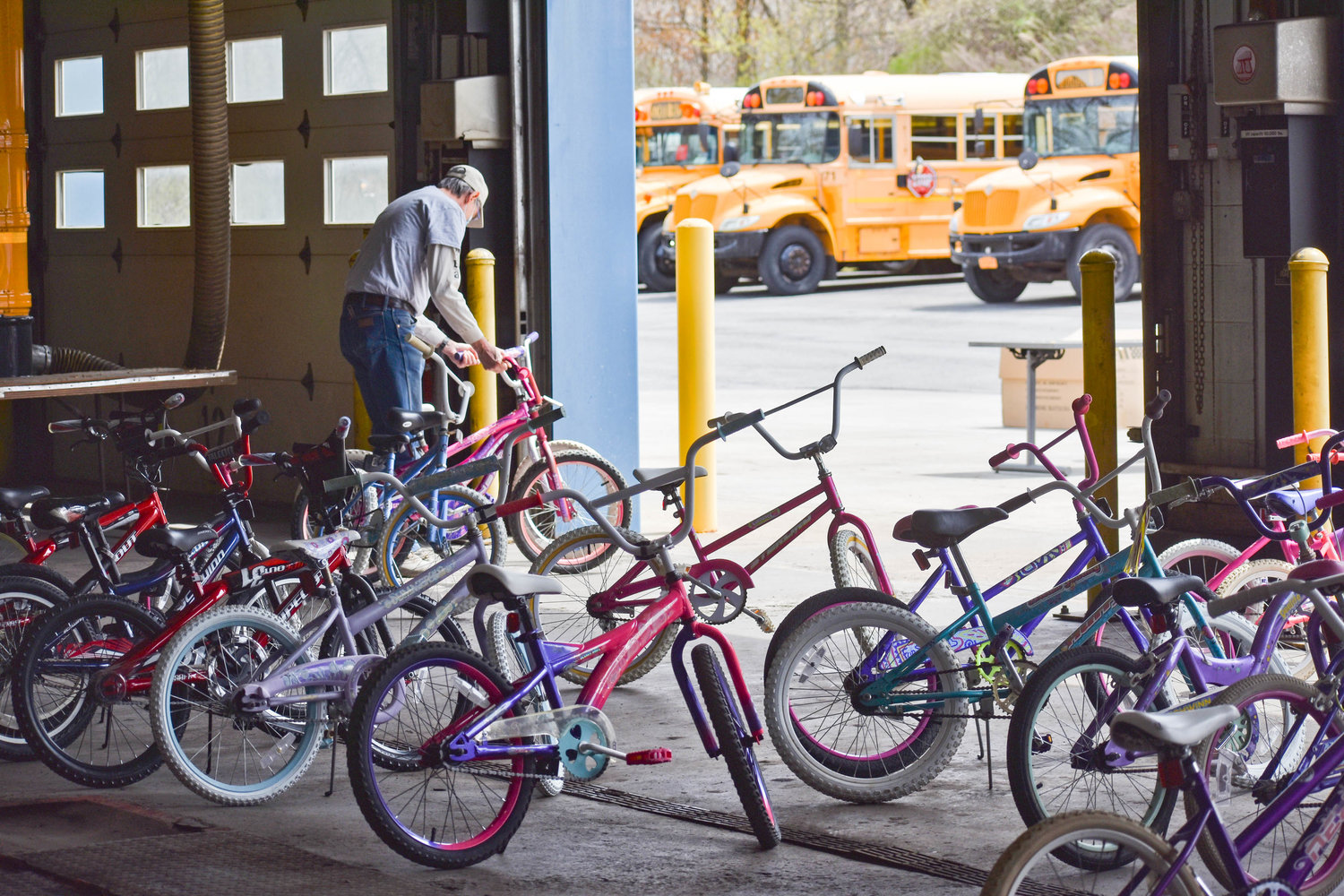 A volunteer organizes leftover inventory at the end of Community Bikes’ giveaway.