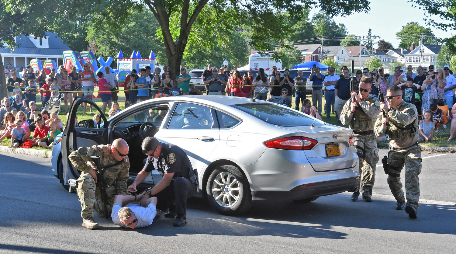 The Rome Police Department's Special Response Team puts on an arrest demonstration for a crowd of people at the department's annual Law Enforcement Day. After a break for the pandemic, the free community day will return to Franklyn's Field on July 23.