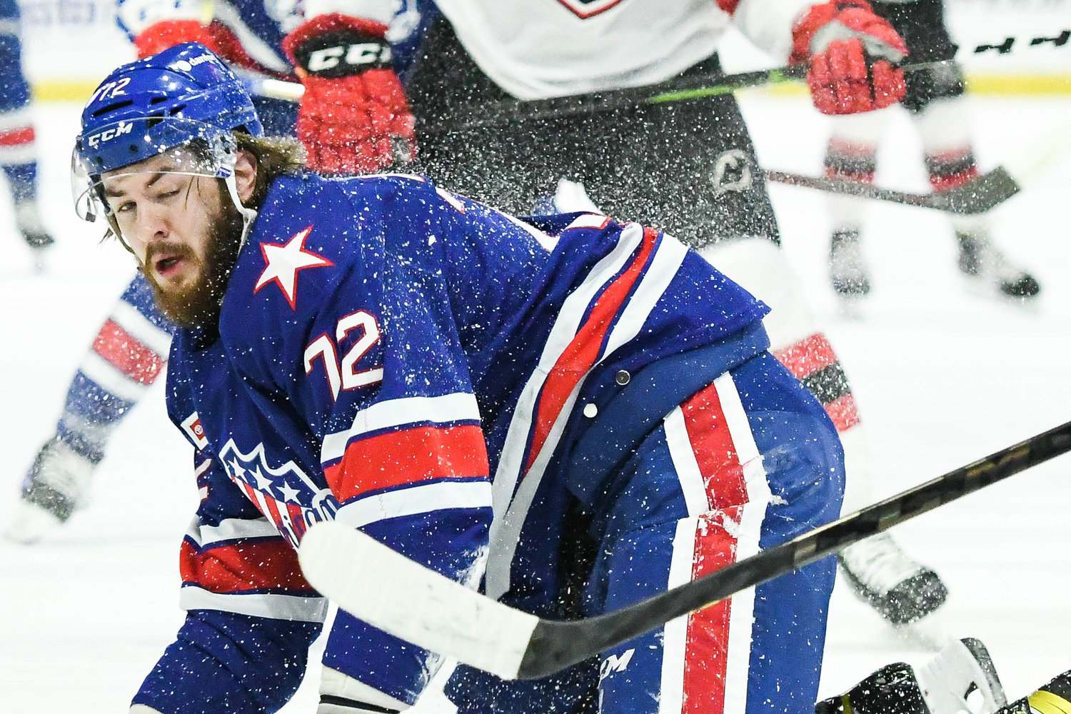 Rochester Americans player Ryan MacInnis is sprayed with snow on the ice during the AHL North Division semifinal round game against Utica on Tuesday night.