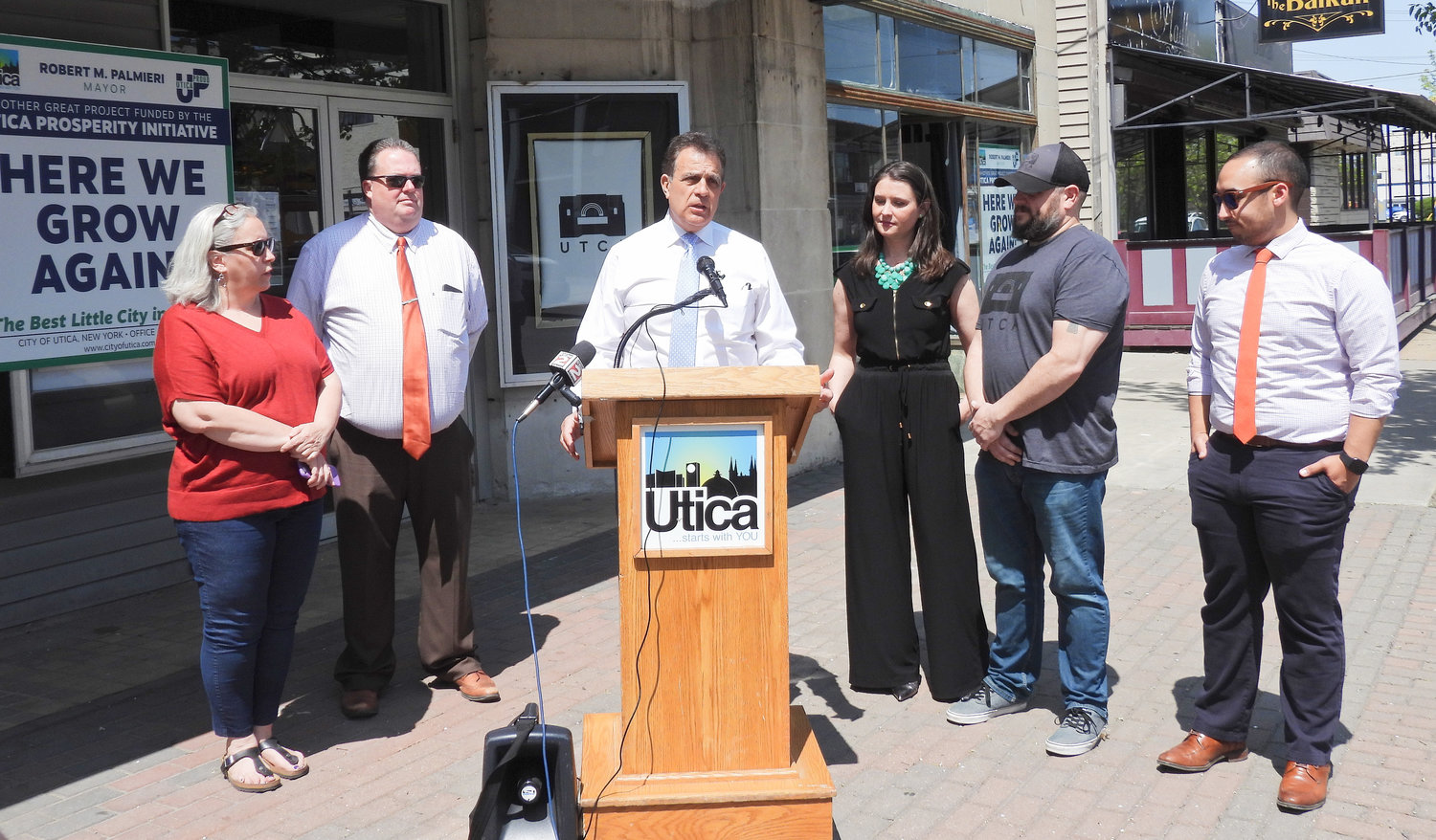 Utica Mayor Robert Palmieri speaks with local officials and the owners of the Uptown Theatre for Creative Arts, where a roof repair is one of many upcoming projects in the city.