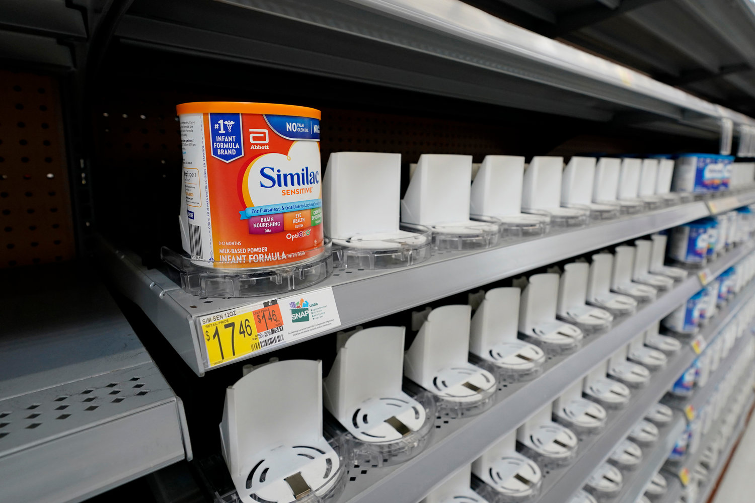 Shelves typically stocked with baby formula sit mostly empty at a store Tuesday.