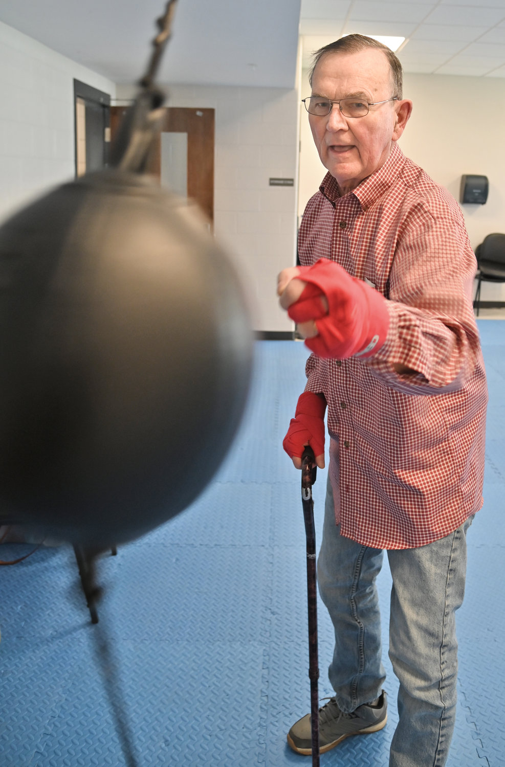 William Angell slugs the speed ball before he puts the boxing gloves on to hit the bag.