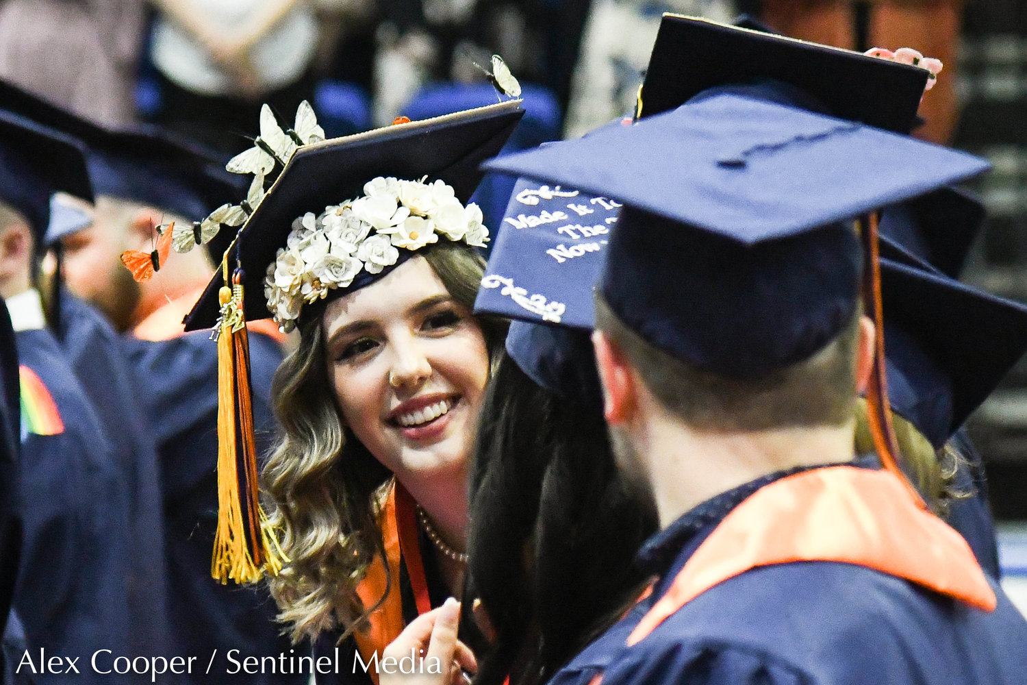 Utica University graduate Amra Becirevic wears a cap decorated with flowers and butterflies during the school's undergraduate commencement ceremony on Thursday afternoon at the Adirondack Bank Center at the Utica Memorial Auditorium.