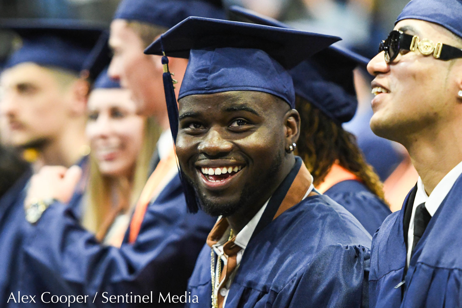 Jordan Marcel O'Brien smiles toward the crowd during Utica University's Commencement Ceremony on Thursday at the Adirondack Bank Center at the Utica Memorial Auditorium.