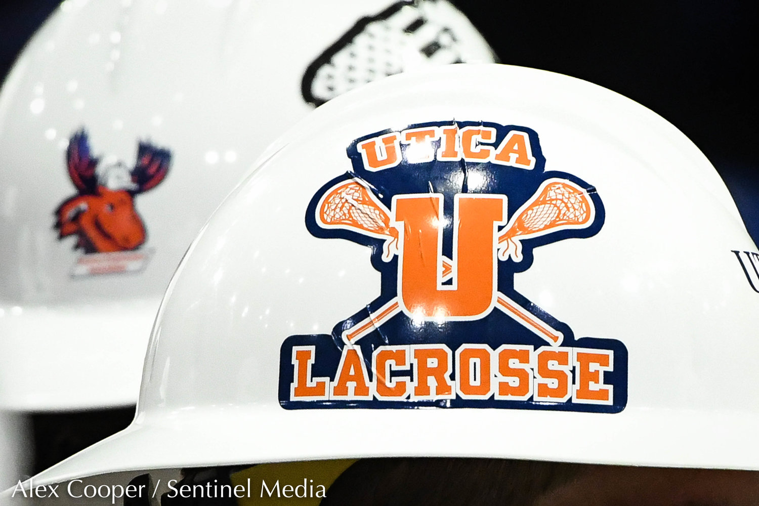A lacrosse sticker is decorated on a safety helmet during Utica University's Undergraduate Commencement Ceremony on Thursday at the Adirondack Bank Center at the Utica Memorial Auditorium.