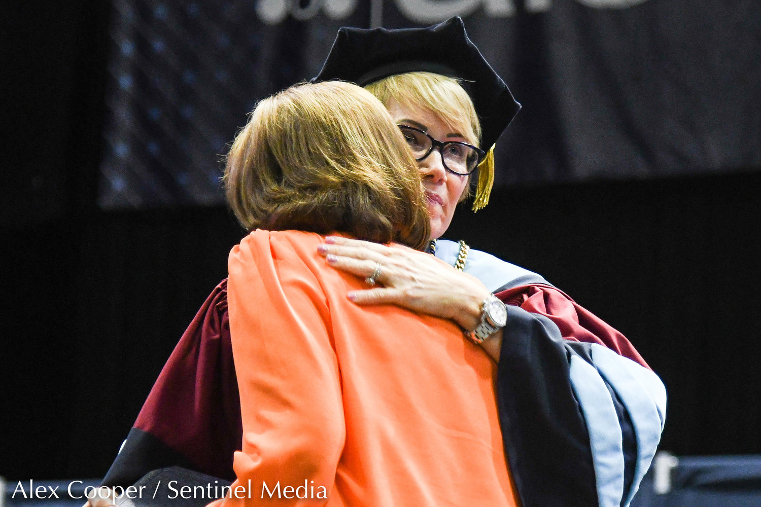 Utica University president Dr. Laura Casamento presents John Paul Ramel's degree to a family member during the school's undergraduate commencement ceremony on Thursday at the Adirondack Bank Center at the Utica Memorial Auditorium.