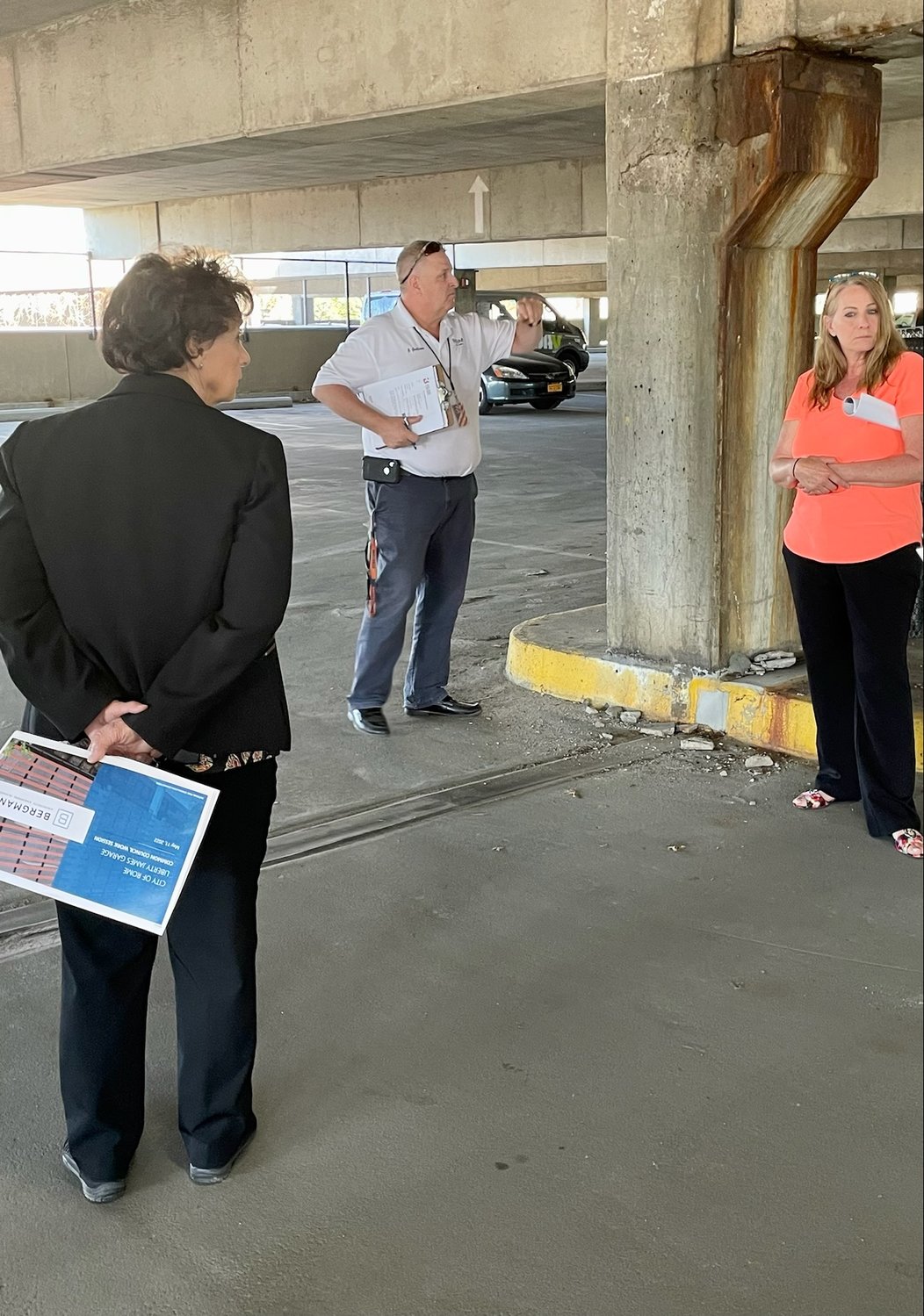 Rome City Engineer II Joseph Guiliano shows Common Council members and city officials the deteriorating condition of a support beam inside the Liberty James Garage Wednesday. Also pictured are Fourth Ward Councilor Ramona L. Smith, left, and Third Ward Councilor Kimberly Rogers. (Sentinel photo by Nicole A. Hawley)