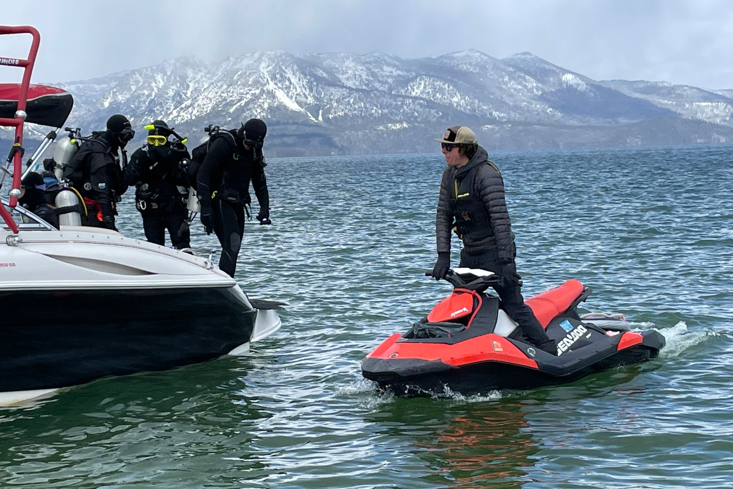 Divers prepare to enter the water at the end of the year-long Lake Tahoe cleanup in Stateline, Nev., Tuesday, May 10, 2022. They found no trace of a mythical sea monster, no sign of mobsters in cement shoes or long-lost treasure chests. But scuba divers who spent the past year cleaning up Lake Tahoe's entire 72-mile (115-kilometer) shoreline have come away with what they hope will prove much more valuable: tons and tons of trash. (AP Photo/Haven Daley)