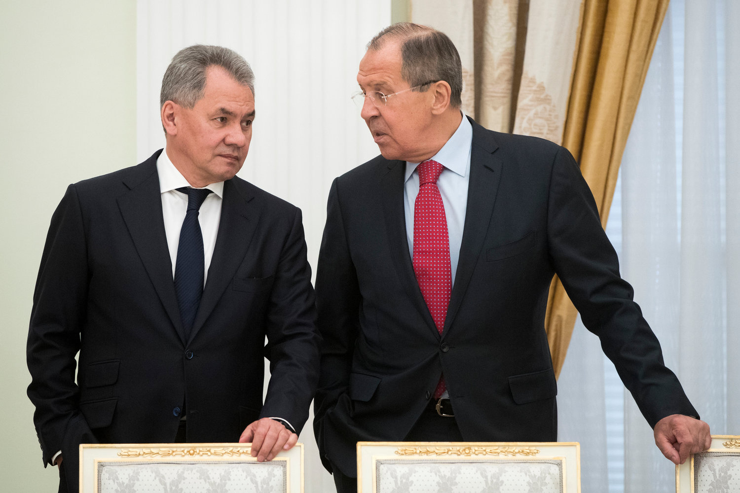 Russian Defense Minister Sergei Shoigu, left, and Foreign Minister Sergey Lavrov talk at the Kremlin, in Moscow on May 30, 2017. (AP Photo/Pavel Golovkin, Pool, File)