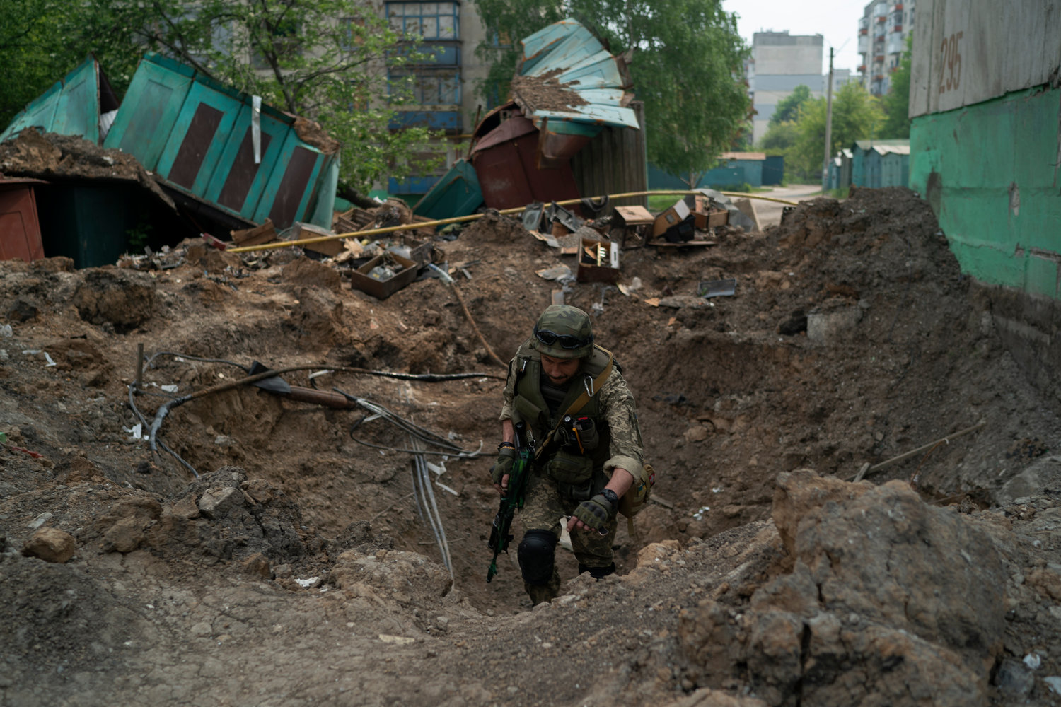 A special task force policeman inspects a site after an airstrike by Russian forces in Lysychansk, Luhansk region, Ukraine, Friday, May 13, 2022. (AP Photo/Leo Correa)