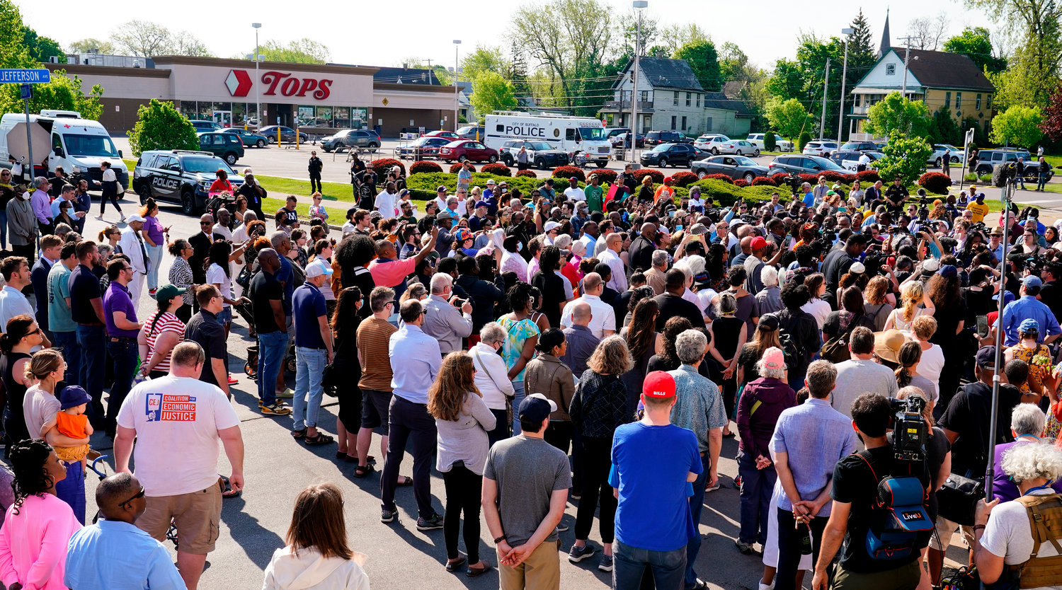 People gather outside the scene of a shooting at a supermarket in Buffalo, N.Y., Sunday, May 15, 2022. (AP Photo/Matt Rourke)