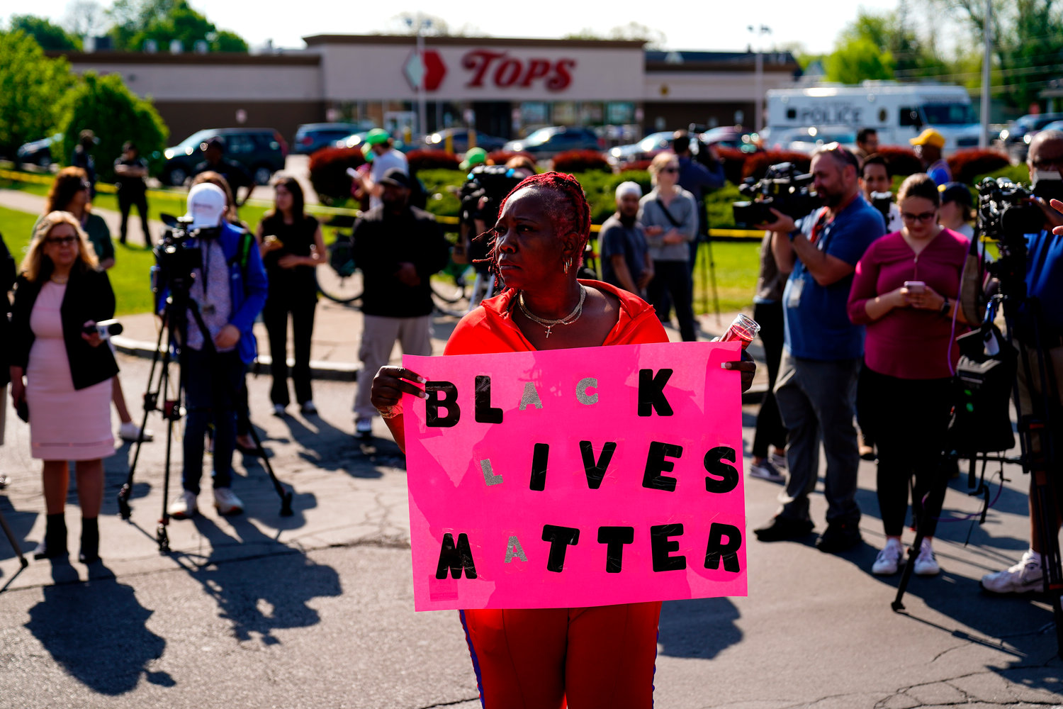 Sharon Doyle gathers with others outside the scene of a shooting at a supermarket, in Buffalo, N.Y., Sunday, May 15, 2022. (AP Photo/Matt Rourke)