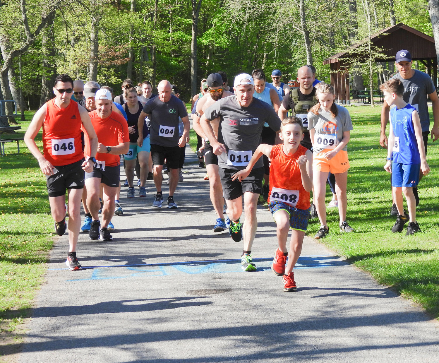 FRONT OF THE PACK — 10-year-old Liam Flint, a fourth-grader at North Broad Elementary takes off at a dead sprint for the Husky Hustle 5k Fun Run and Walk at Verona Beach State Park. The Husky Hustle raises money for the North Broad Elementary PTO.
