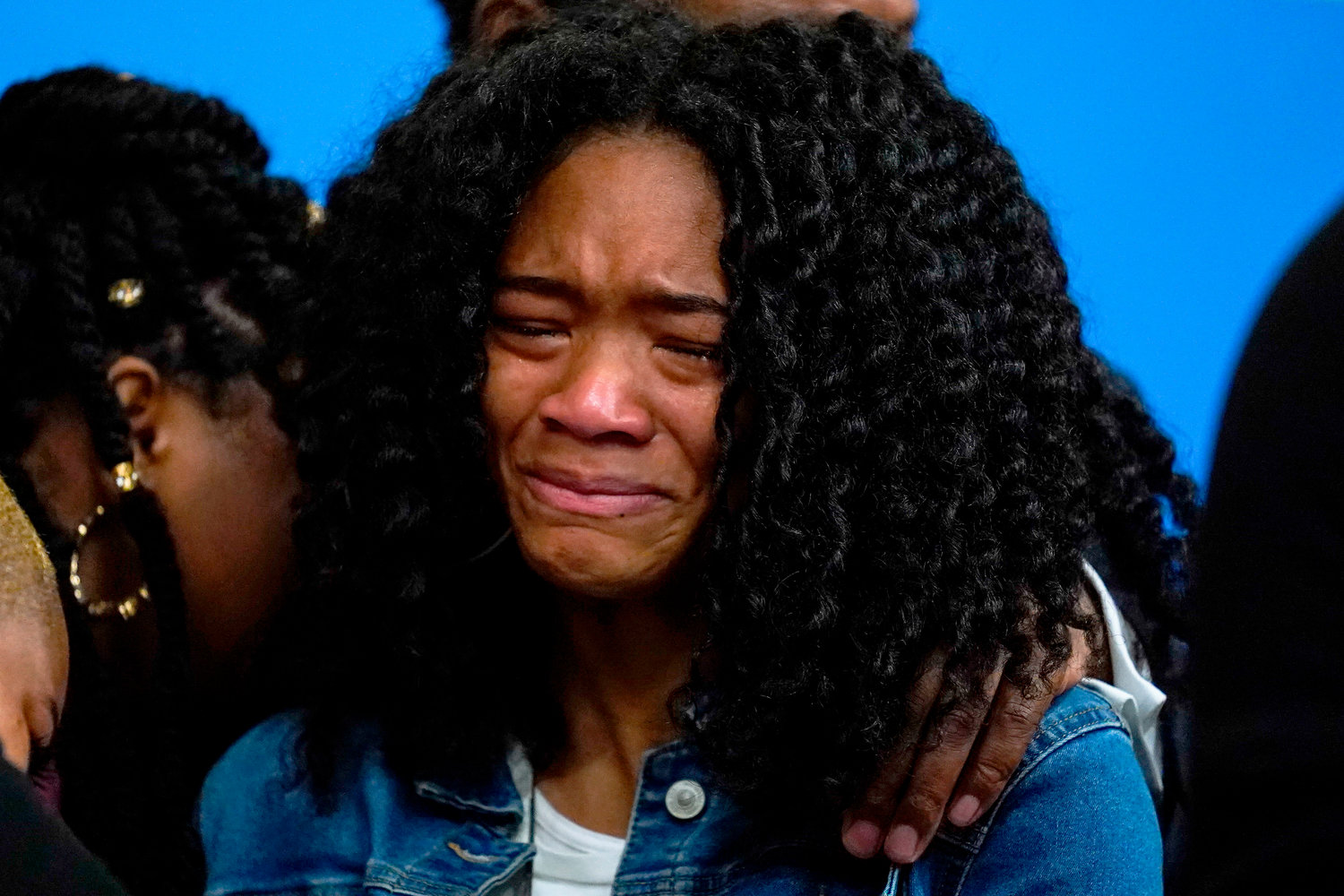 Lauren Gibson, a great granddaughter of Ruth Whitfield, a victim of shooting at a supermarket, is overwhelmed with emotion during a news conference in Buffalo, N.Y., Monday, May 16, 2022. (AP Photo/Matt Rourke)